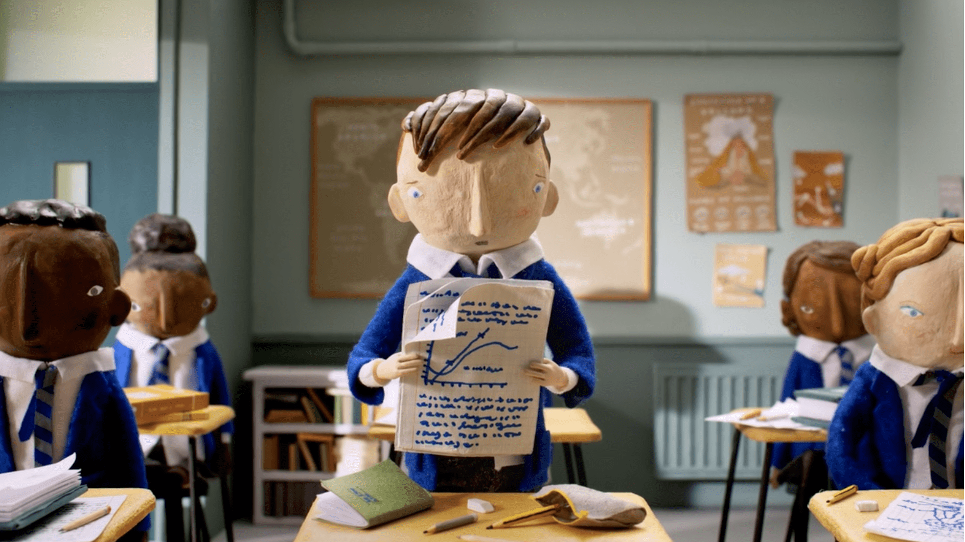 Childline, still from stop animation of a young boy reading out homework in a classroom from the Nobody is Normal campaign