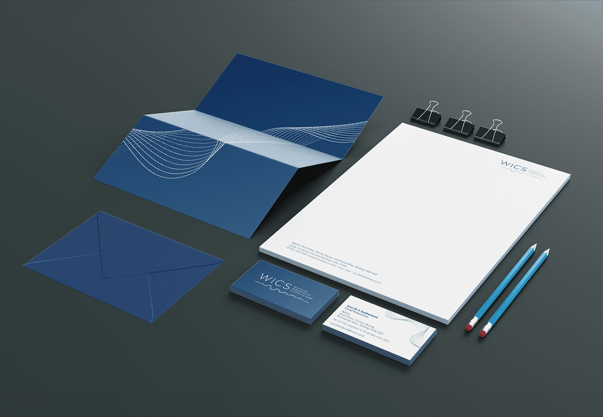 Various pieces of mocked up WICs stationery including envelopes, business cards, letter heads and pencils.